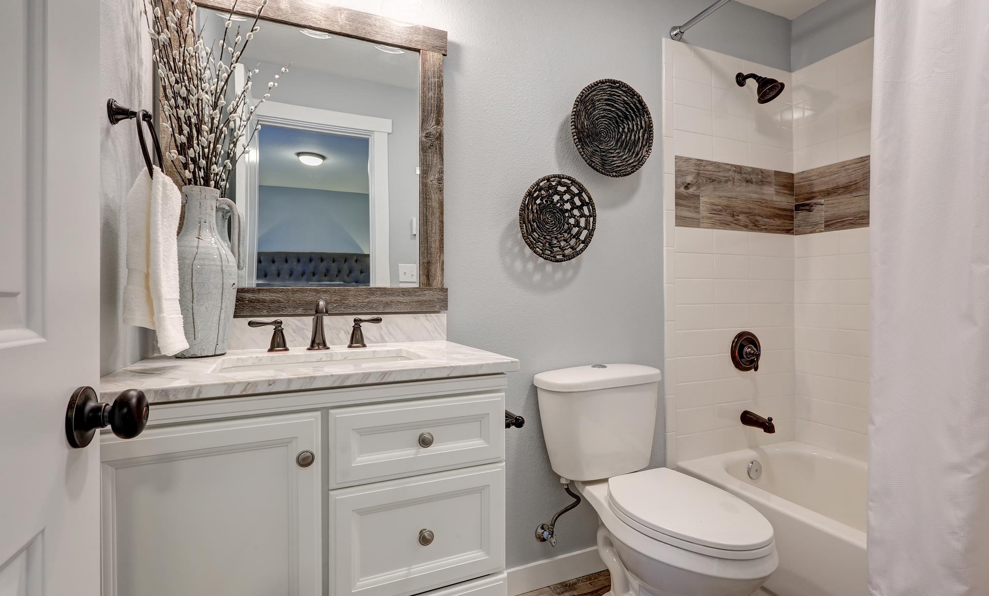 photo of a small bathroom with a lavatory, a mirror and a bath